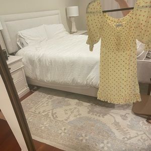 Yellow mini dress with flowers. Worn once. So cute for summer!
